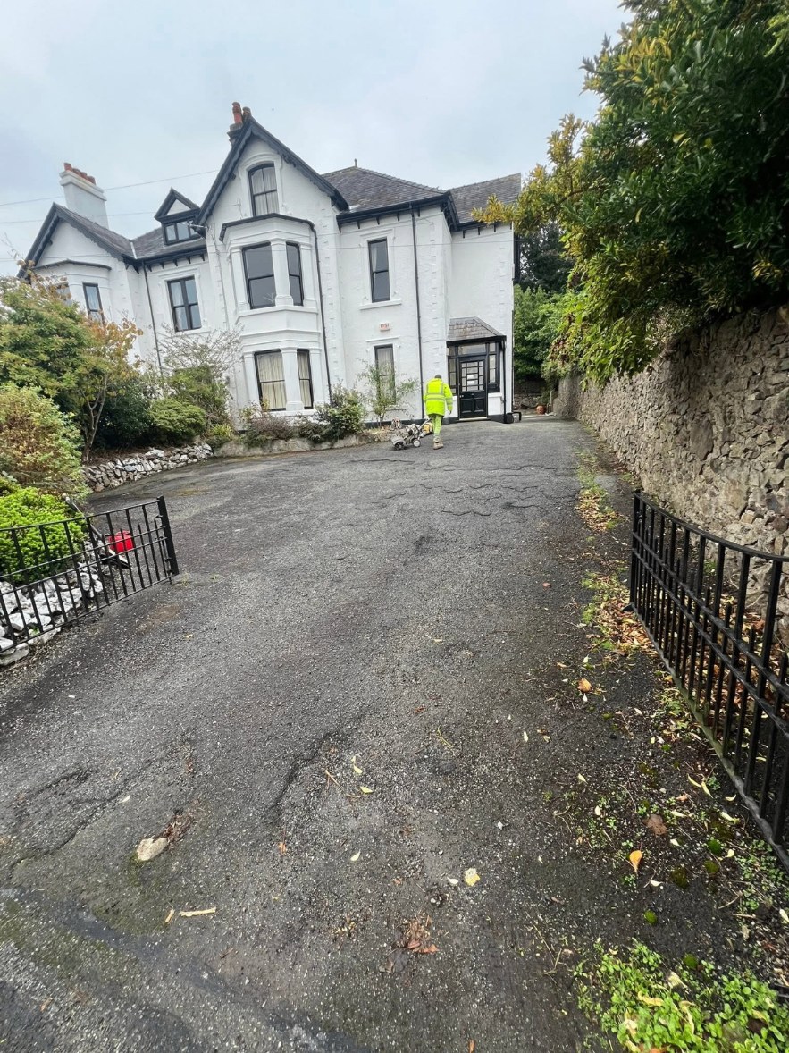 Damaged tarmac driveway before repair